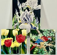 Lot display of three ceramic decorative tiles: one large iris flower tile and two smaller tiles with floral and bird designs.