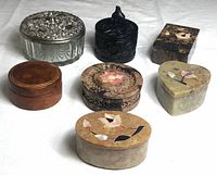 Overview photo showing all seven assorted trinket boxes in different styles and materials on a white surface.