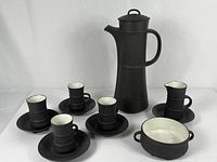 Full set arranged together: carafe, creamer, sugar bowl, four cups and saucers