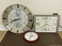 Photo of all three clocks together showing Diling round clock, Power rectangular clock and Cardinal round clock