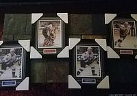 Four framed NHL photos displayed together showing two Henrik Sedin photos, one Daniel Alfredsson and one Patrick Lalime.