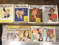 Eight issues laid out on wood floor showing four early-1930s covers and four mid-1960s covers