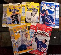 Multiple Post cereal boxes featuring Wayne Gretzky photos from various years and promotions spread on floor, showing front of boxes