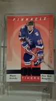 Single Wayne Gretzky hockey card in New York Rangers uniform in clear plastic case from Pinnacle Be a Player series.