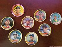 7 Topps 1989 Metal Baseball Coins featuring Paul Molitor, Kevin Seitzer, Mark McGwire, Jose Canseco, and others arranged in a circular pattern