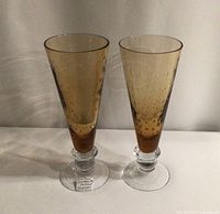 Pair of amber tinted handblown pilsner glasses with controlled bubble pattern, shown side by side, front view.