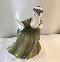 Front and side views of Royal Doulton Simone porcelain figurine showing detailed paint and features.