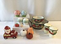 Full view of lot including the Royal Doulton and Fitz and Floyd sets along with various novelty salt and pepper shakers including pumpkins and vegetables