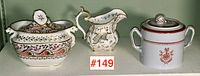 Three-piece lot of antique sugar bowls and cream pitcher shown together with label #149