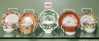 All five cup and saucer sets displayed side by side