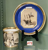 Cup and saucer displayed together showing overall appearance, gilt rims, cobalt panels, and classical scenes