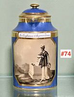 Front view of cobalt blue porcelain lidded pitcher showing overall shape, gilt trim and transfer print scene