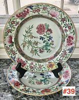 Pair of plates on easel showing full front design and gilt rims