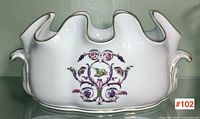 Front view of white porcelain tureen showing floral arabesque motif