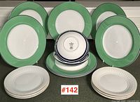 Overall lot arrangement with green-rim plates, blue-striped bowls and fluted rim plates