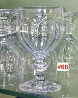 Single goblet front view showing faceted bowl and stem