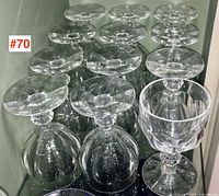Twelve wine goblets arranged upright and inverted on shelf