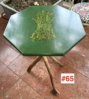 Full view of octagonal green lacquered top with asparagus motif and twig base