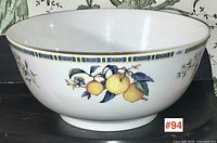 Front view of Wedgwood Citron bowl showing yellow citron fruit design and blue yellow border trim.