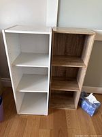 Front view of the two small bookshelves side by side, showing compartments and finishes