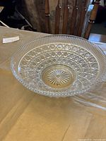 Shallow crystal bowl with lattice and circle pattern on a table