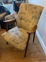 Front and side view of the fabric chair showing upholstery pattern and wooden arms.