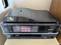 Epson Artisan 835 printer closed showing status and touchscreen interface.