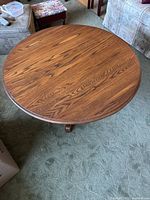 Top-down view of the round oak coffee table showing wood grain and surface condition.