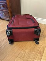 Photo from the bottom side showing four wheels and suitcase structure.