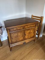 Front view of the walnut antique buffet showing drawer, cabinet doors, and carved details.