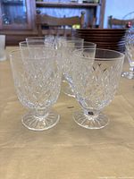 Front angled view showing the set of six Waterford sherry glasses with detailed diamond cut patterns.