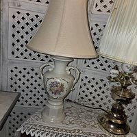 Side view of ceramic floral lamp with beige shade showing detailed floral pattern and lamp shape