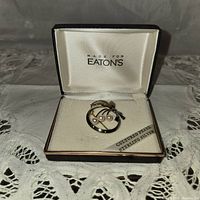 Full view of vintage pearl and sterling silver brooch in original Eaton's box