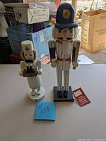 Front view of nurse and baseball player nutcrackers showing details and condition.