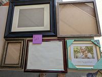 All five assorted picture frames shown together on floor with sticky note #027