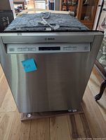 Exterior front view showing stainless steel panel and control buttons.