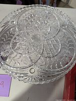 Top view of glass pedestal cake tray showing detailed etched patterns