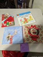 Four children's books on table including A Special Christmas Eve, Teddy Bear, Teddy Bear, Turn Around, Someday, When Susan Was a Baby