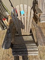 Front view of the wooden Muskoka chair showing the seat, armrests, and fan-shaped backrest of vertical slats.