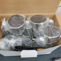Box containing 10 individual solar lights still factory sealed in plastic wrapping.