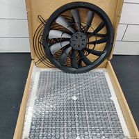 Photo showing the fan and solar panel inside the box with bubble wrap on solar panel.