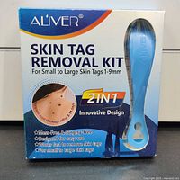 Front of sealed box showing brand Aliver and blue applicator visible through packaging