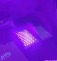 Two rectangular LED black light panels emitting purple UV light, showing the illumination effect.