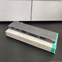 7-in-1 USB C Adapter Hub showing ports USB-C, HDMI, card readers, USB 3.0 with box under it