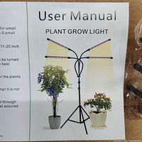 User manual showing diagram and details of the 4-way plant grow light on a tripod stand.