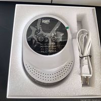 iCARE ozone air purifier ionizer with power cord inside white foam packaging showing front with digital display and control buttons