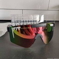 Front view of Pit Viper sunglasses showing green reflective polarized lens and white PTV logo.