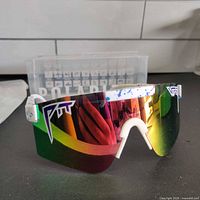 Front view of Pit Viper polarized sunglasses showing white frame with paint splatter accents and multicolor mirrored lens.