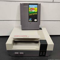 Retroflag NESPi 4 Case with cartridge-style Raspberry Pi holder on top of the NES-style console case, showing front angled view.