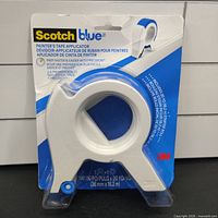 Front view of the sealed Scotch Blue painter's tape applicator packaging showing product details and branding.